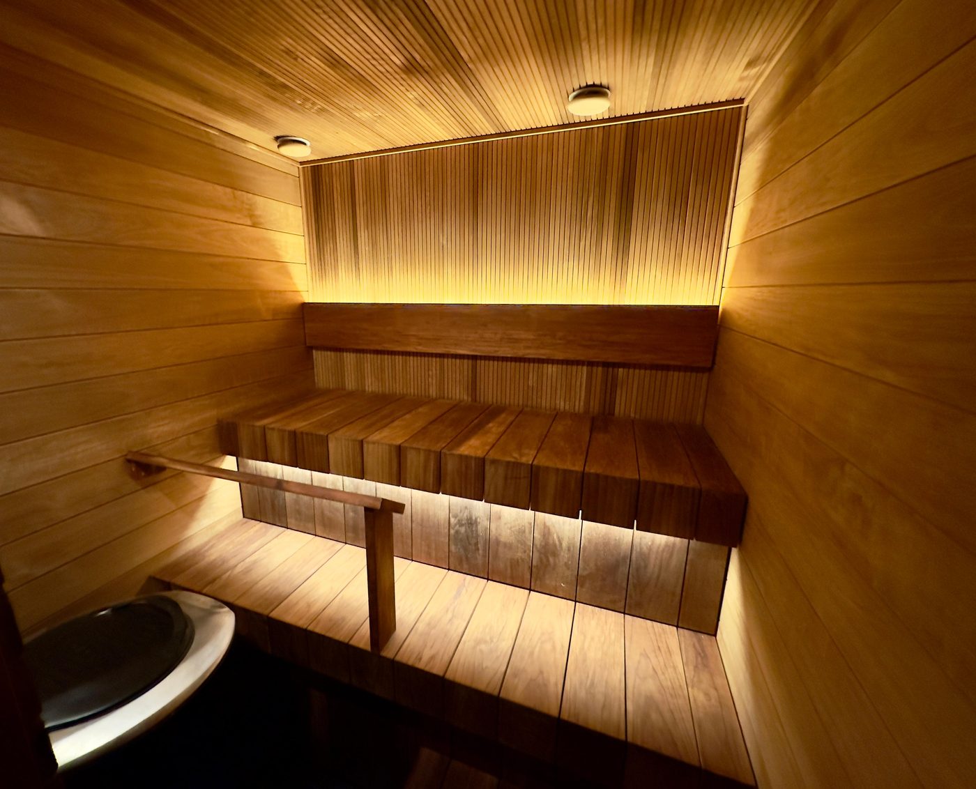 Sauna, jossa kiuas ja valaistus asennettuna